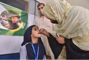 A child aged four months to 10 years receive fractional IPV booster doses, while those aged five months to 10 years are administered oral polio vaccine during an anti-polio campaign.