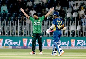 Cricket teams of Pakistan and Sri Lanka stand at attention as their national anthems are played before the start of the T20 International cricket match between the two sides at Rawalpindi Cricket Stadium.