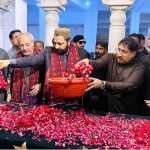 Chief Minister of Gilgit-Baltistan Amjad Hussain Advocate showering flowers at the grave of Shaheed Mohtarma Benazir Bhutto at Garhi Khuda Bakhsh Bhutto