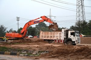 Workers are engaged in construction work on the underway Kashmir Chowk Underpass (Dhokri Chowk) project along Murree Road in the Federal Capital.