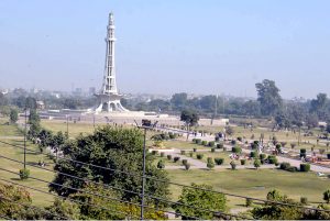 A view of the historic Minar-e-Pakistan at Greater Iqbal Park as visitors enjoy a pleasant day in the park.
