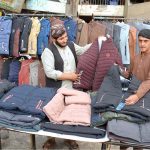 Vendor set up winter coats for customers near main Chowk