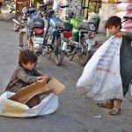 Children collecting empty boxes to sell in the market for livelihood at Mission Road
