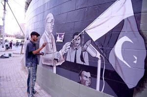 An artist paints a wall at the historic Sindh Governor House, adding colour and artistic expression to the surroundings during the beautification work in the provincial capital.