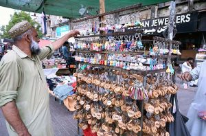 An elderly man is selling towels in Bohra Bazaar