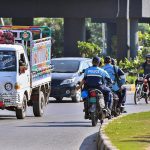 Police official ride their motorcycles against the flow of traffic without wearing safety helmets at Rawal Dam Chowk which sheer violation of traffic rules