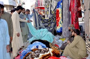 A man purchase warm shawls at Liaquat Bazaar as the winter season approaches.