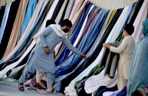 A man purchase warm shawls at Liaquat Bazaar as the winter season approaches.
