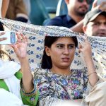Spectators watch the cricket match between the England and Pakistan teams during the ODI Tri-Nation Series at Rawalpindi Cricket Stadium