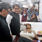 Federal Minister for Railways Muhammad Hanif Abbasi inquires about the health of an injured passenger during his visit to Nishtar Hospital following the derailment of the Rehman Baba Express near Sher Shah Railway Station