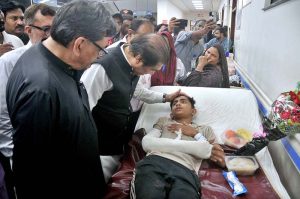 Federal Minister for Railways Muhammad Hanif Abbasi inquires about the health of an injured passenger during his visit to Nishtar Hospital following the derailment of the Rehman Baba Express near Sher Shah Railway Station
