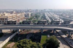 Newly acquired 25 BRT buses are transported by trucks from Karachi Port to the BRT headquarters.