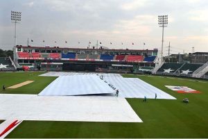 Women police officials shield themselves with umbrellas from the rain before the start of the third T20 cricket match between Pakistan and Sri Lanka at Rawalpindi Cricket Stadium