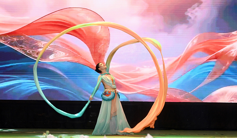 A Chinese artist performs a traditional dance with long flowing ribbons during the launch ceremony of the China-Pakistan Information Corridor (CPIC) at the Pakistan-China Friendship Centre
