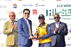 Divisional Commissioner Dr. Imran Hamid Sheikh and Sri Lankan High Commissioner Admiral Fred Seneviratne present the trophy to the captain of the victorious Sri Lanka Under-19 Women’s team after the T20 tri-series final at Iqbal Stadium.