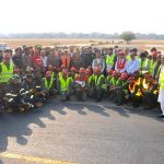 A group photograph of officials, emergency response personnel, Rescue 1122, fire brigade teams and security staff during a full-scale emergency exercise conducted by the Pakistan Airports Authority (PAA) at Multan International Airport to evaluate operational readiness and equipment functionality